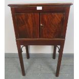 A Georgian mahogany washstand with brass handles to either side, on inner chamfered square