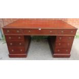 A late Victorian mahogany kneehole partners desk, having a leather inset top over 12 short drawers