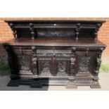 A large oak 19th century sideboard, ornately carved in a 16th century taste with lion masks and