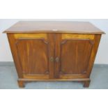 A 19th century mahogany side cabinet, the two doors opening onto a loose shelf over two short