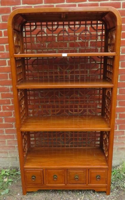 A contemporary Chinese hardwood open bookcase of four shelves, with open fretwork to sides and