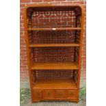 A contemporary Chinese hardwood open bookcase of four shelves, with open fretwork to sides and