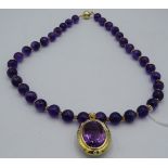 An 18ct yellow gold pendant set with large amethyst, approx 25mm x 18mm and surrounded by 12