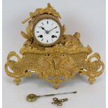 An antique ornate French gilt striking clock with movement stamped H.P. & Co 15911. Height 28cm. Key