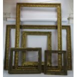 A pair of large antique gilt gesso picture frames, each 99cm x 147cm and three smaller gilt gesso