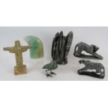 A carved fossil sculpture, two carved stone leopards, a green quartz claw, a green stone bird and