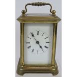 A brass cased 8 day carriage clock with enamel dial. Overall height 13cm. No key. Condition