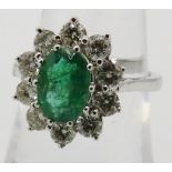 Certificated 18ct white gold oval emerald & diamond cluster ring, size M. Emerald approx 1.20ct.
