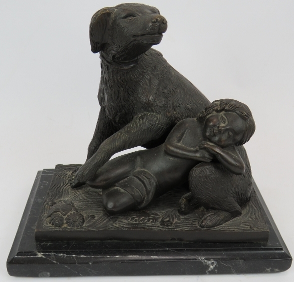 A bronze figure of a dog and sleeping child mounted on a black marble plinth. Signed B.M.18.