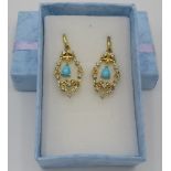 A pair of Sleeping Beauty earrings, 34mm length, post back, 14k/yellow gold/925. Condition report: