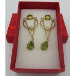 A pair of peridot earrings, 45mm length, post back, 14k/yellow gold and sterling silver. Condition