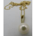 A 9ct yellow gold yellow gold round freshwater cultured pearl and diamond pendant on a 9ct yellow