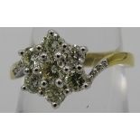 An 18ct yellow gold seven stone diamond daisy cluster ring, size O, round brilliant cut diamonds,