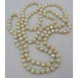 A string of possibly cultured pearls, 46" long, each pearl knotted through a very small hole. Each