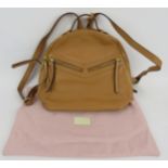 A Radley tan zip top backpack handbag in grained hide. Original card and dust bag. All handbags