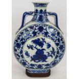 An antique Chinese porcelain Ming style moon flask with Ruyi-head handles, peach and bat