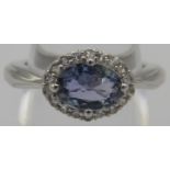 A natural tanzanite ring, 12mm x 8mm, halo setting, size J, platinum/925. Condition report: Good