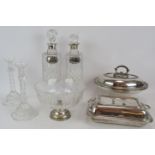 A pair of cut crystal glass candlesticks, two spirit decanters, one with hallmarked silver collar,