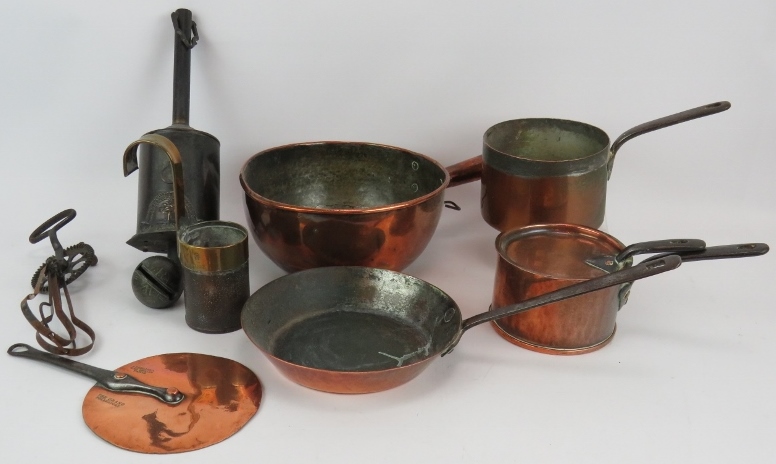 A collection of antique kitchen ware including four copper pans, a half pint measure, an early egg