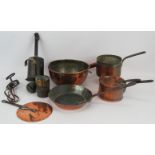 A collection of antique kitchen ware including four copper pans, a half pint measure, an early egg
