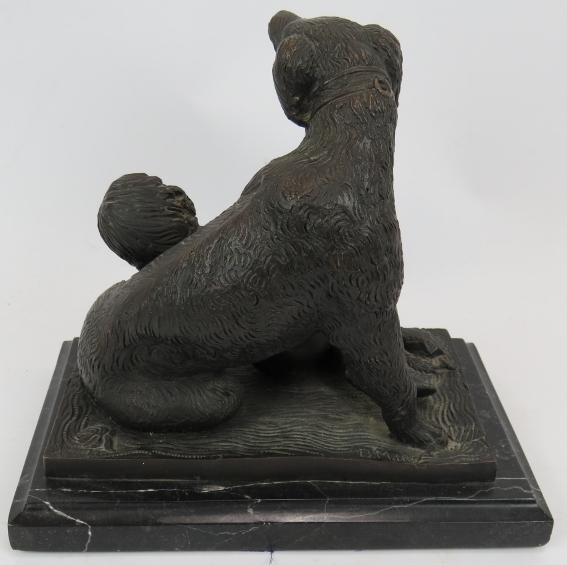 A bronze figure of a dog and sleeping child mounted on a black marble plinth. Signed B.M.18. - Image 2 of 4