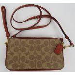 A Coach small monogram leather and canvas shoulder bag with twin zipped pockets. All handbags