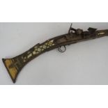 An Antique Middle-Eastern Jezail flint lock rifle with ornately inlaid bone and brass stock, Length: