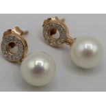 A pair of 9ct rose gold pearl and diamond halo bale earrings. Round cut diamonds approx 0.15ct.