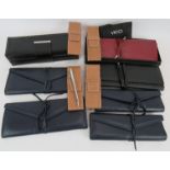 Six brand new leather jewellery rolls and four Vicci propelling pencils in leather wallets. (11).