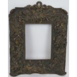 An antique bronze Baroque Revival picture/mirror frame with multiple putti figures in relief. Traces