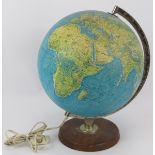 A 1970s Danish Scan Globe illuminated terrestrial globe on turned wood stand and with chrome axis.