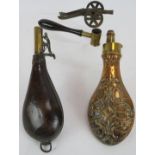 An ornate 19th Century Hawksley copper powder flask, a similar leather shot flask, a James Dixon &