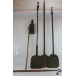 Three antique iron baker's paddles, a night watchman's lamp on pole and a hand forged shepherd's