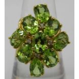 A large peridot ring, setting 25mm x 20mm, size Q, oval brilliant cut stones, good cut, colour &