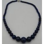 A fine lapis lazuli bead necklace, 20" length, polished graduated beads, largest 15mm, good colour