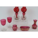 A pair of Victorian triple lobed cranberry glass garnitures, three pieces of hand enamelled and