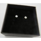 A pair of 18ct white gold claw-set round brilliant cut diamond solitaire stud earrings, post