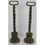 A pair of cast brass lion's paw door porter door stops with weighted bases. Height 38cm. (pr).