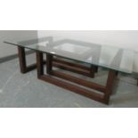 A modernist rectangular coffee table with glass top raised on an asymmetric oak base. Condition