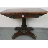 A Willian IV rosewood turnover card table, with gadrooned edging and carved frieze, on a tapering