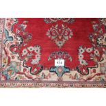 A mid 20th century Persian rug central pattern on red ground. 180cm x 140cm (approx). Some wear to
