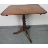 A Georgian oak rectangular tilt-top wine table, on a baluster turned pedestal with tripod base.