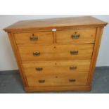 An Edwardian satin walnut chest of two short over three long graduated drawers, with pressed brass