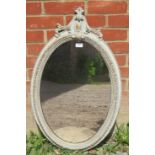 A 19th century oval gilt gesso wall mirror, the surround overpainted with a light wash of grey.
