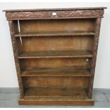 A 19th century oak tall open bookcase of three height adjustable shelves, featuring acanthus