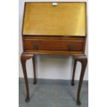 A 1920s mahogany bureau, the fall front opening onto a fitted interior, over one long drawer, on