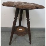 A turn of the century hardwood Anglo Indian two-tier occasional table, with relief carving depicting
