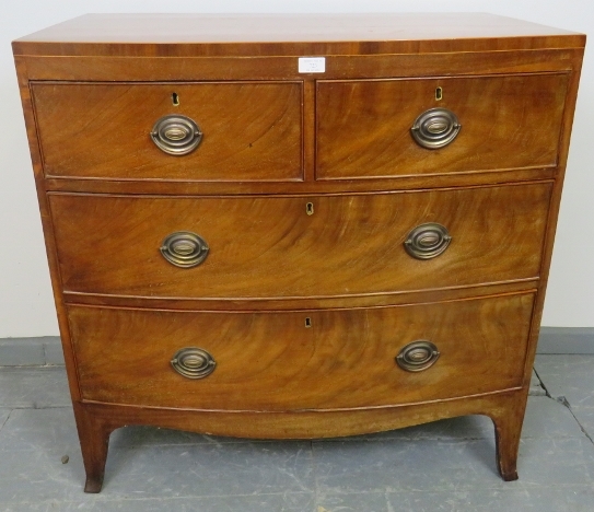 A Regency Period bow fronted mahogany chest of two short over two long graduated cock-beaded