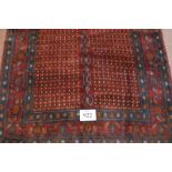 A Senneh rug central panel of small repeated design with a large central blue line pattern. Good