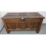 A 17th century panelled oak coffer with fielded panels to top and all four sides and carved